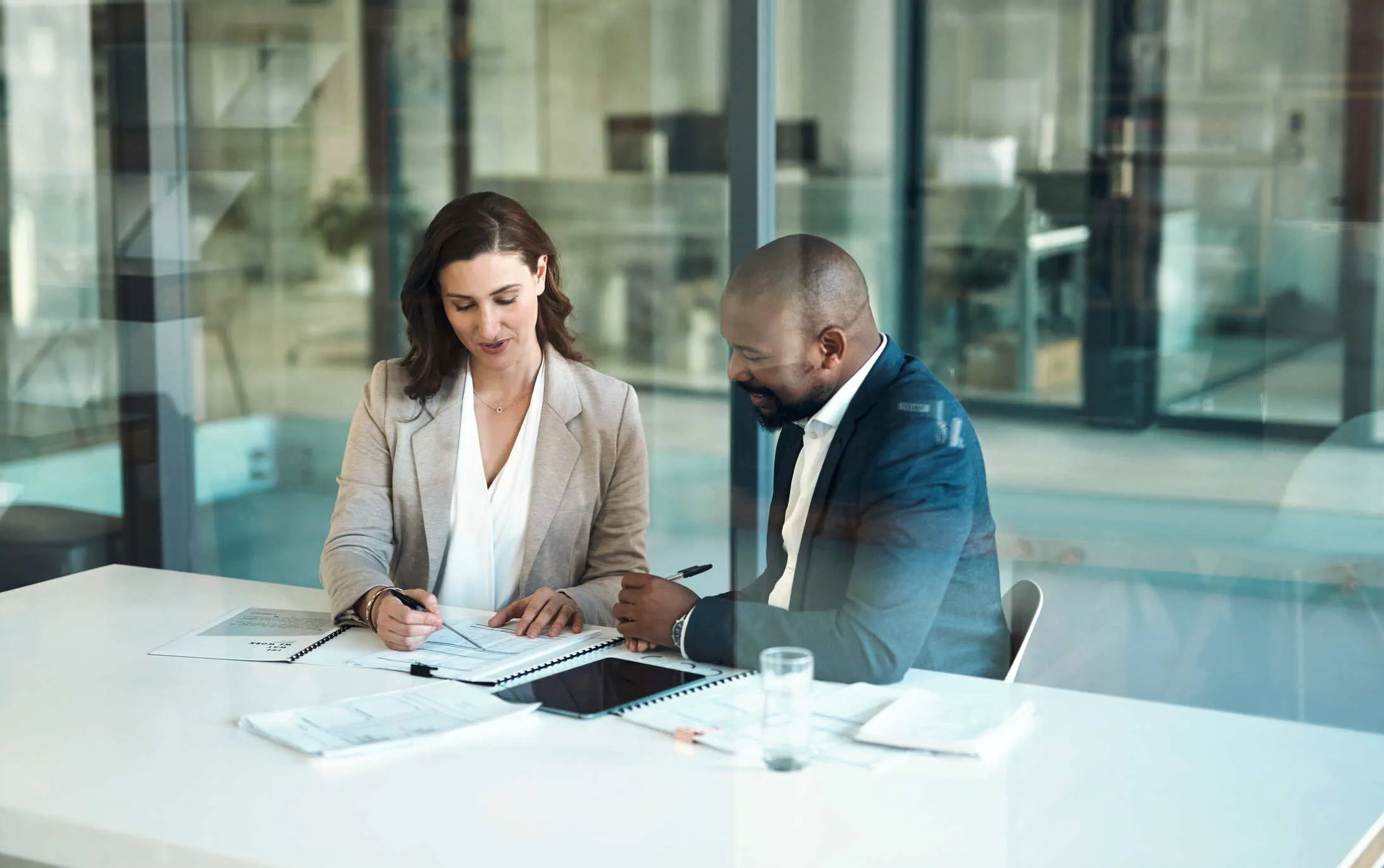 Man and woman reviewing papers together at an office desk