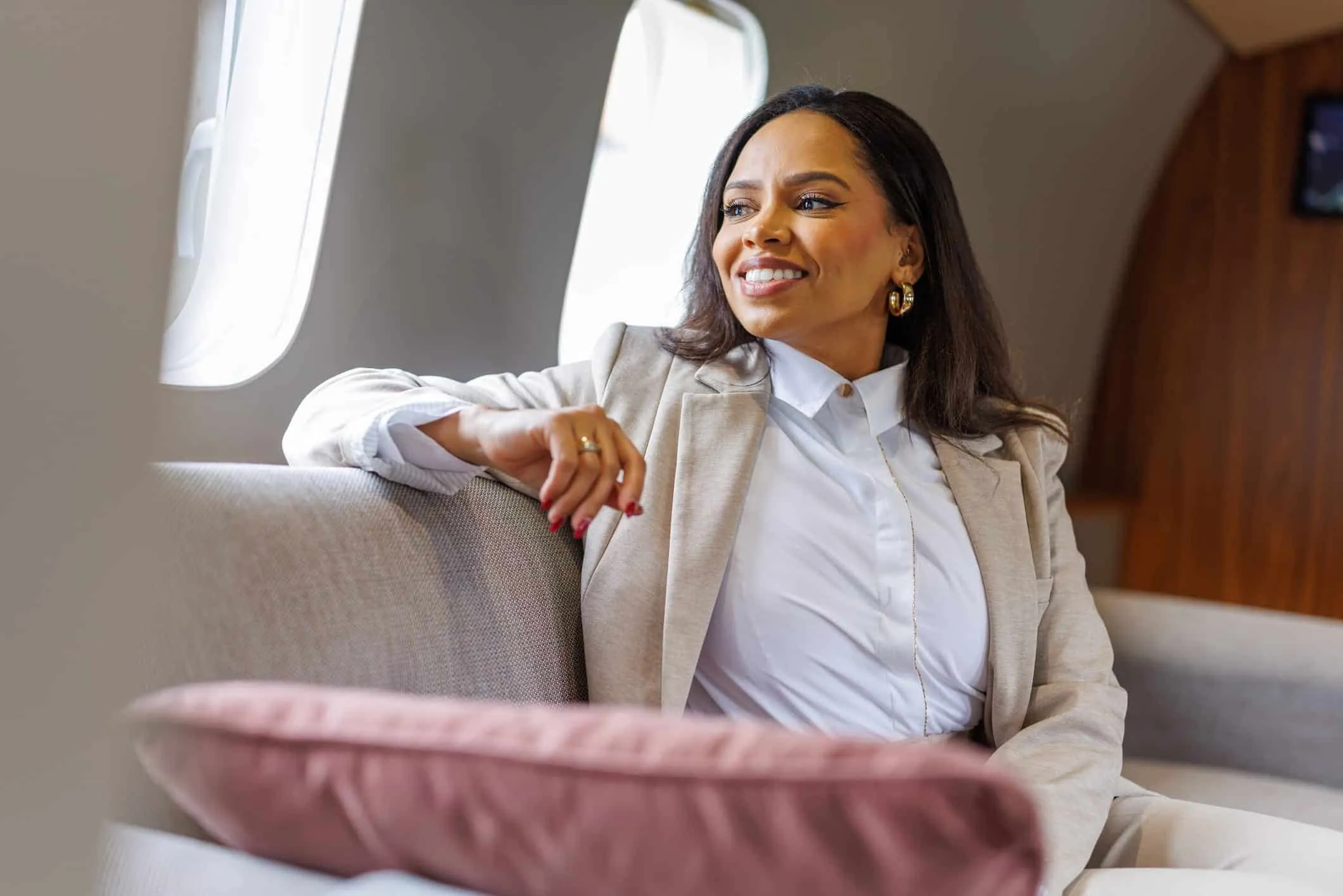 Woman relaxing on a sofa in a private jet cabin